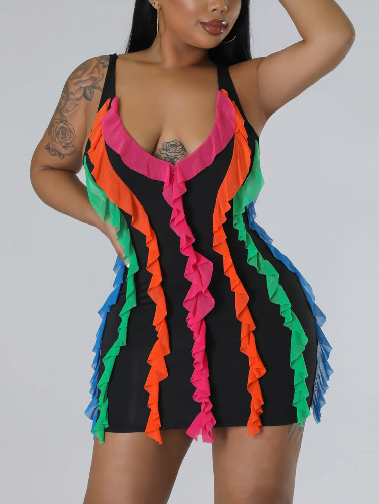 Close-up of a woman wearing a black sleeveless mini dress with vibrant pink, orange, green, and blue ruffled trim along the V-neckline and sides.