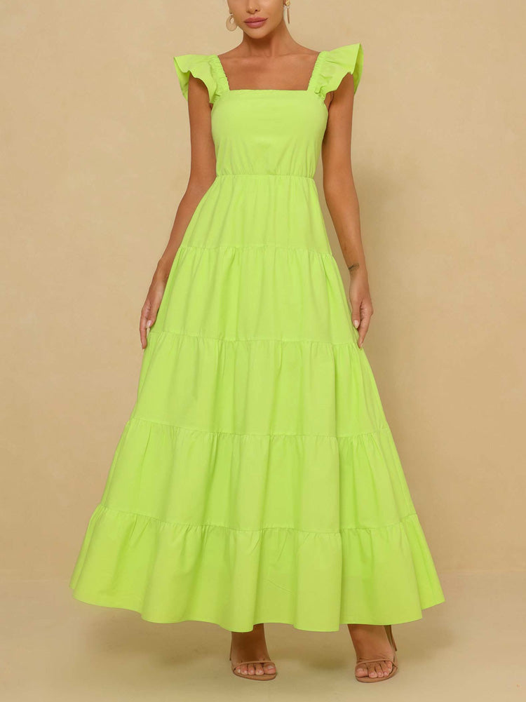 Woman wearing a lime green tiered maxi dress with flutter sleeves and a square neckline, front view.
