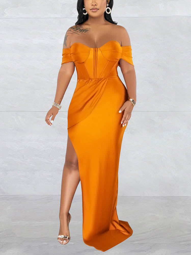 Woman wearing a floor-length golden yellow off-the-shoulder dress with a high slit