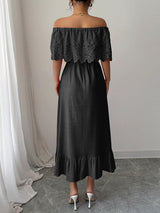 Woman wearing a black off-the-shoulder maxi dress with lace bodice and ruffled hem, back view