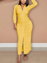 Woman wearing a yellow ruched button-down maxi dress with a high slit