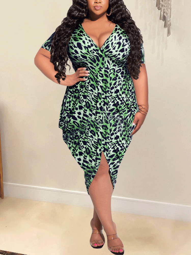 Plus-size woman wearing a green leopard print V-neck dress with short sleeves and an asymmetrical hem.