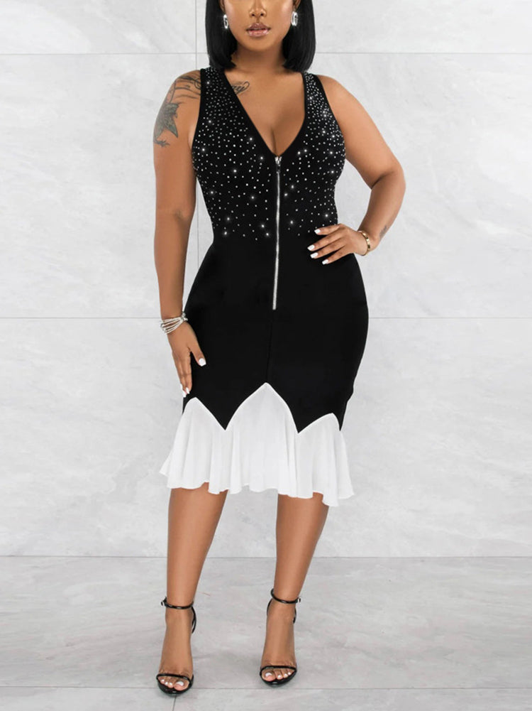 Woman wearing a sleeveless black V-neck dress with a zippered front and a white ruffled hem.