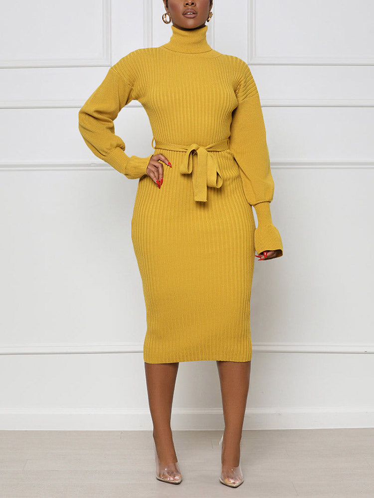 Woman wearing a yellow ribbed knit midi dress with a turtleneck and belt