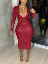 Woman wearing a red sequined long-sleeve midi dress with a deep V-neckline.