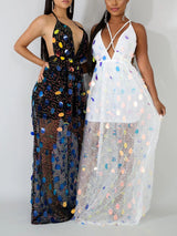 Two women posing, one in a black sequined maxi dress and the other in a white sequined maxi dress.