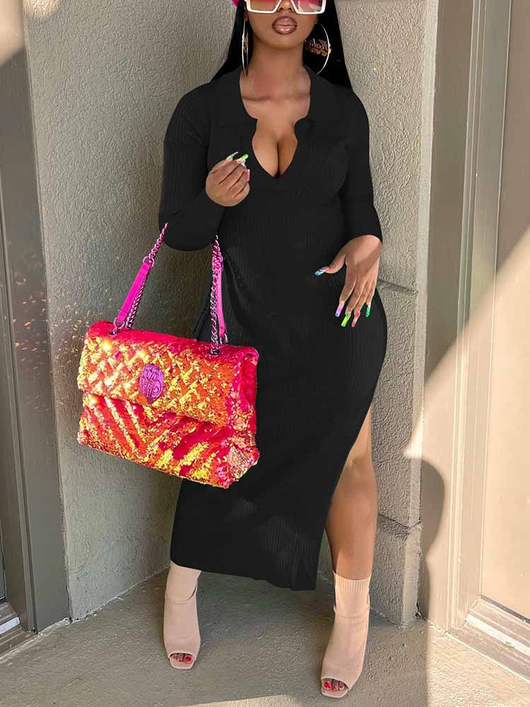 Woman wearing a black ribbed knit midi dress with long sleeves and a v-neck collar, accessorized with a pink sequined handbag and tan heeled boots.