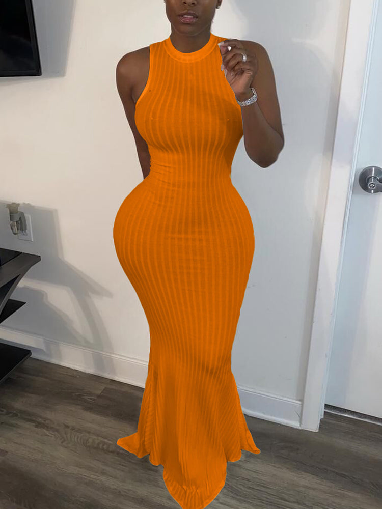 Woman wearing an orange sleeveless ribbed knit maxi dress with a mermaid hem and mock neckline.