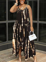 Woman wearing a black and white tie-dye maxi dress with spaghetti straps and a v-neckline.