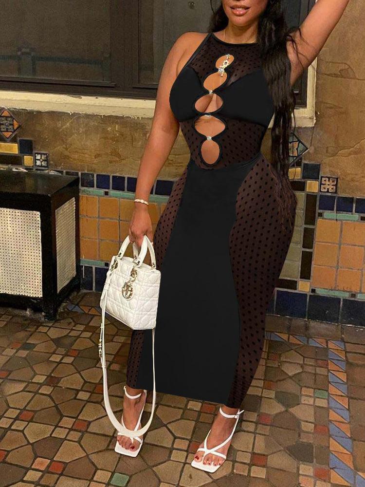 Woman wearing a black sleeveless bodycon dress with mesh side panels and cut-out neckline, holding a white handbag.