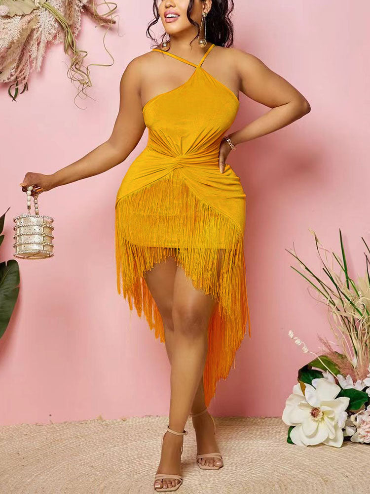 A woman wears a yellow halter neck mini dress with fringe detailing and an asymmetrical hemline.