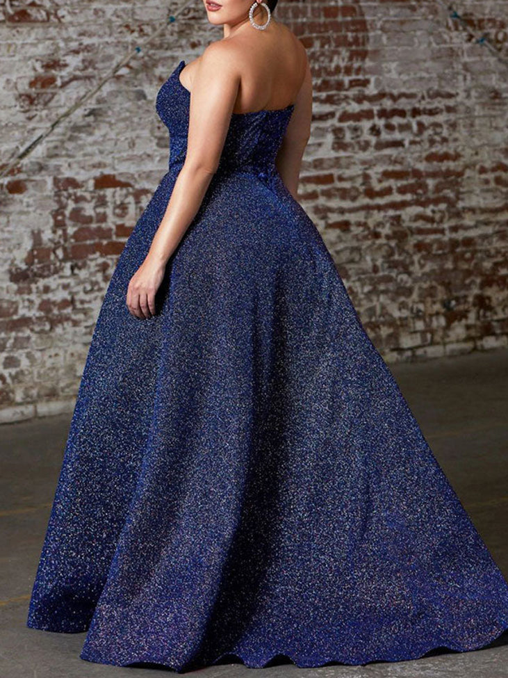 Back view of a navy blue sparkly strapless ball gown with a full skirt.