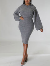 Woman wearing a grey hooded knit sweater and pencil skirt set, front view.
