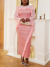 Woman wearing a pink patterned midi dress with bell sleeves and ruffled details.