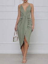 front view of a green ruched halter dress with an asymmetrical hemline