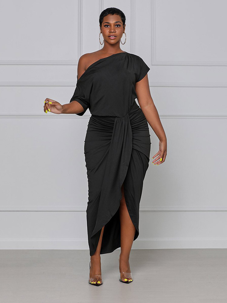 woman wearing a black one-shoulder draped dress with a high slit