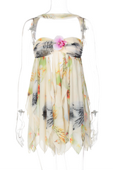 pink strapless babydoll dress with floral embellishment and ruffled hem displayed on a mannequin