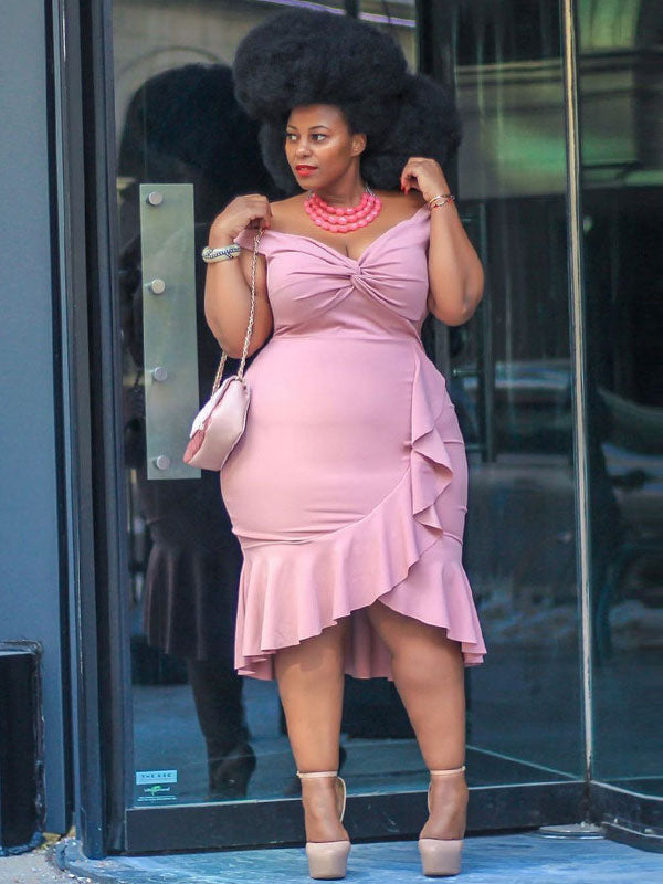 Close-up of a woman in a pink off-the-shoulder dress, showcasing the ruched bodice and ruffle trim.
