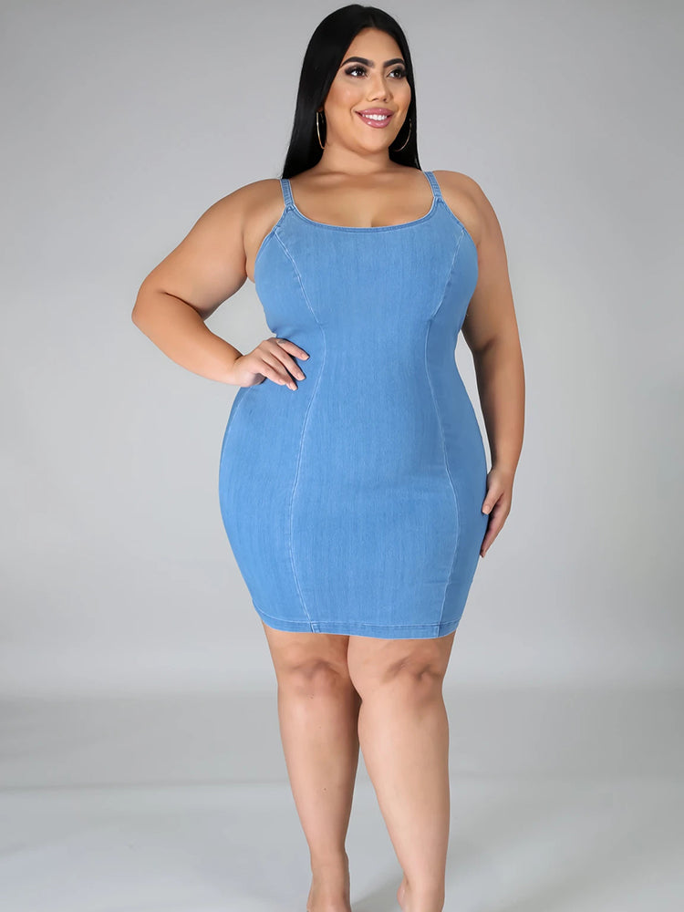 Full body view of a woman in a blue denim sheath dress.