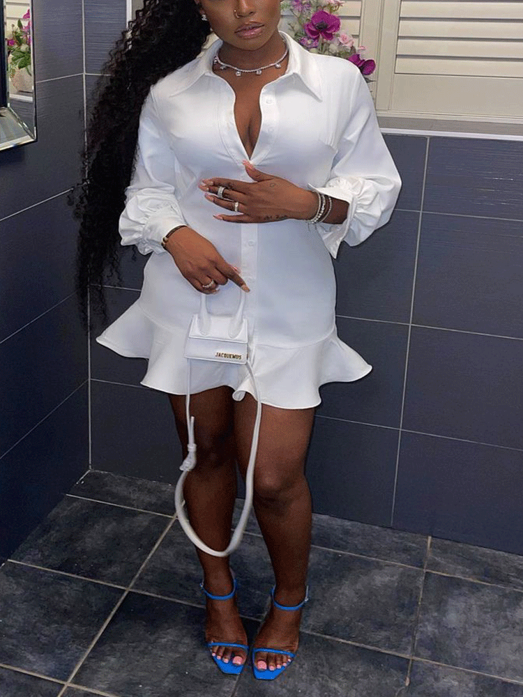 woman wearing a white collared shirt dress with a ruffled hem and balloon sleeves