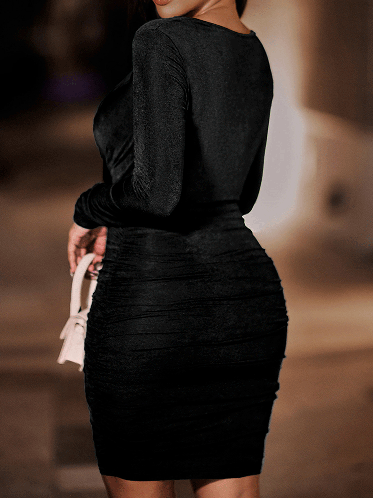 Back view of a woman wearing a black ruched bodycon dress with a halter v-neck and long sleeves.
