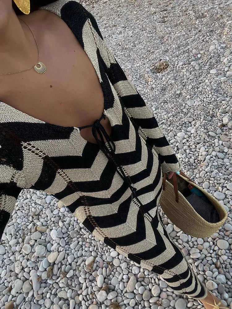 Close-up of the neckline and chevron pattern on a black and beige knit maxi dress