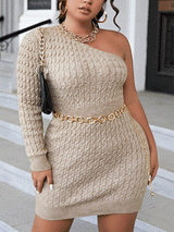 Woman wearing a beige cable knit one-shoulder mini dress with a gold chain belt and necklace.