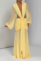 Full-length shot of a yellow dress with a plunging V-neck, ruched detailing, and sheer skirt, shown against a white background.
