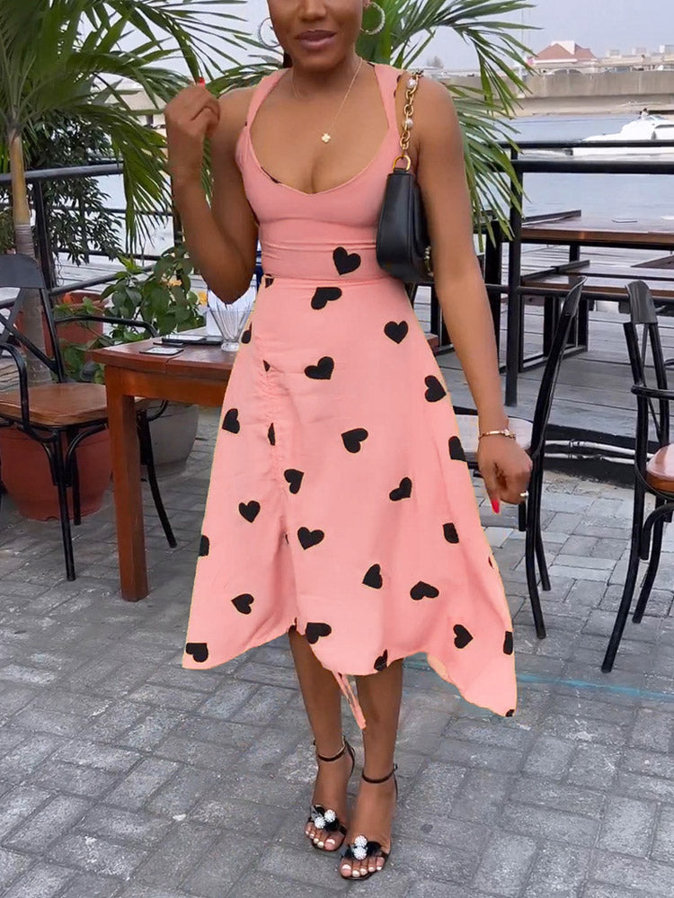 Front view of a woman in a pink heart-print dress with ruched detailing.