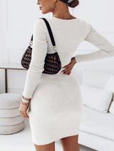 Back view of a woman wearing a white long-sleeved bodycon dress with a cut-out neckline.