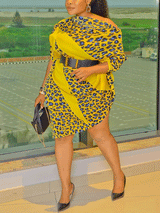 Full-body shot of a woman in a yellow leopard print dress with an asymmetrical hem.