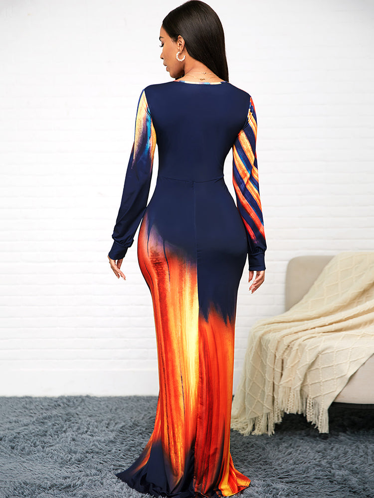 Back view of a woman in a long, fitted dress with an abstract print.