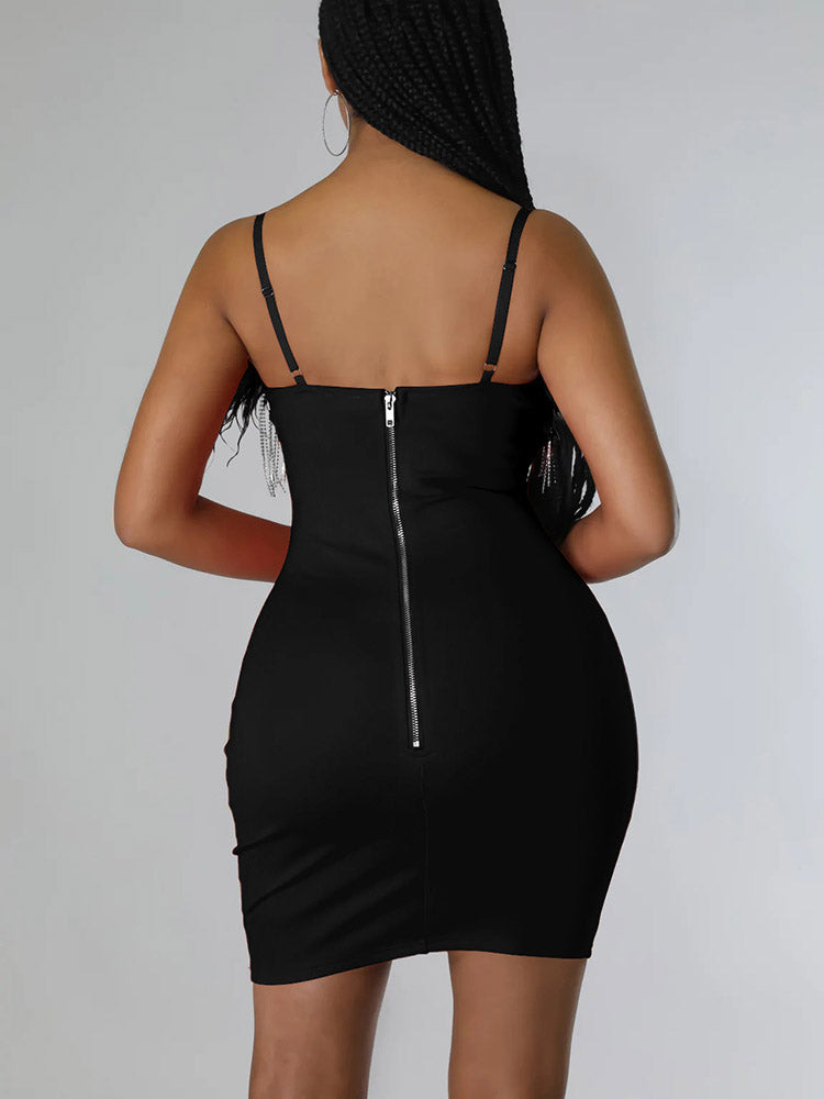 Model posing in a black, fitted dress with decorative trim