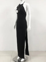 side view of a black floor-length halter dress with a high slit and white floral embellishments on a mannequin