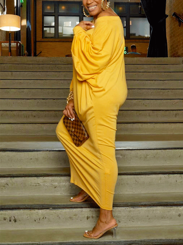 Side profile of a woman in a yellow off-the-shoulder maxi dress
