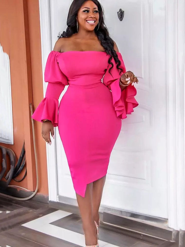 Woman in a bright pink off-the-shoulder dress with ruffled sleeves, standing outdoors.