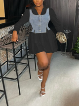 Woman in a black collared shirt dress with a denim vest overlay and white sandals