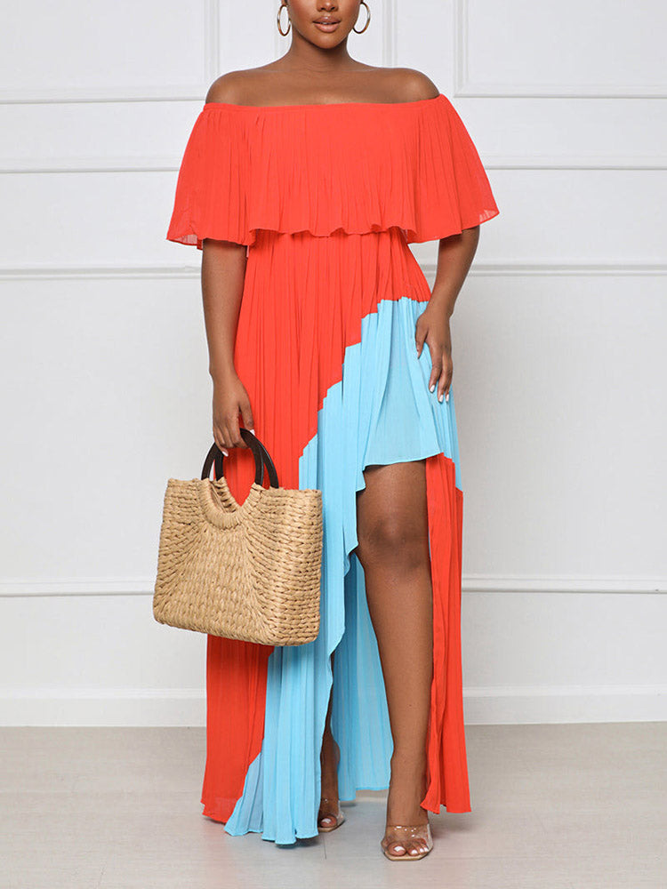 Woman holding a woven straw handbag while wearing a colorblock maxi dress.