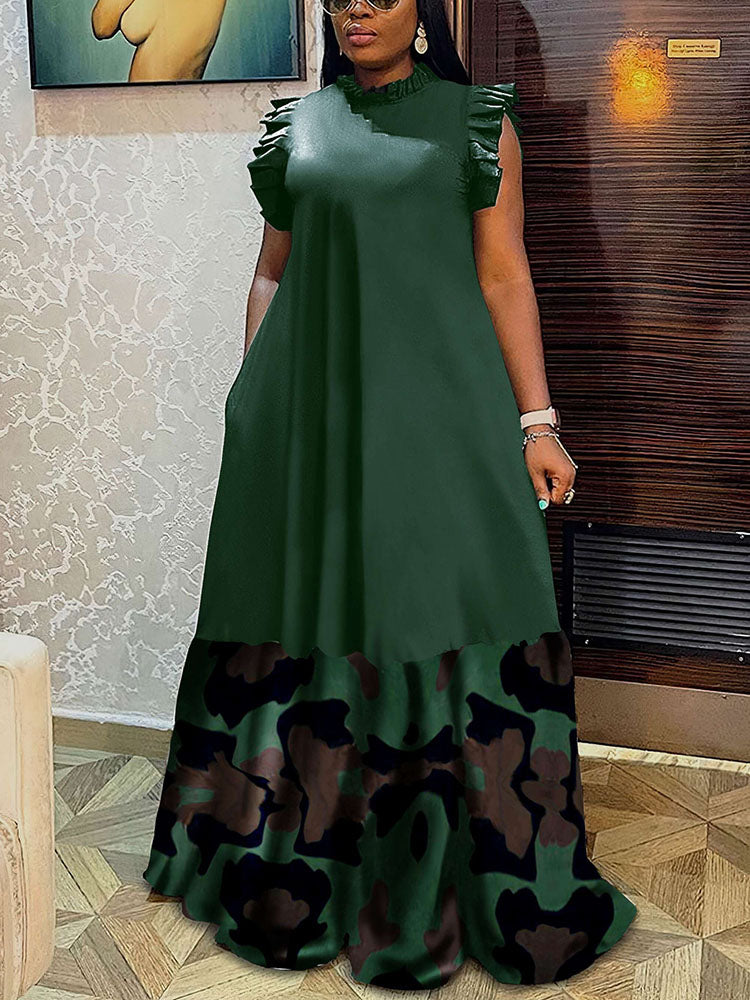 Woman wearing a green maxi dress with a camouflage print hem