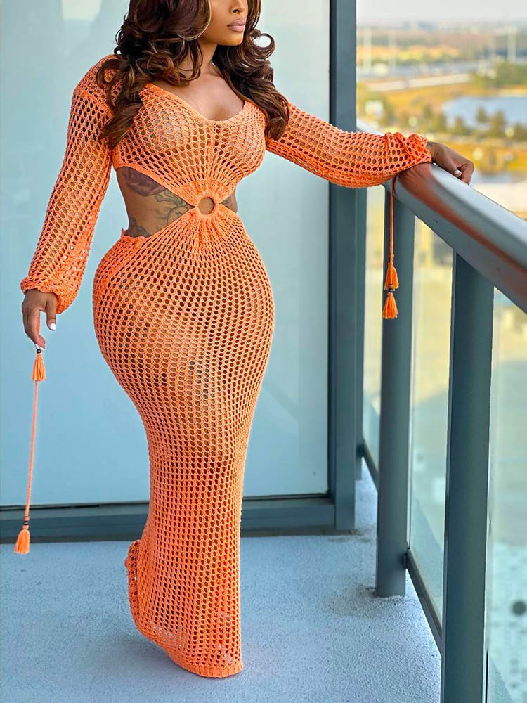 Close-up of the waist detail on an orange crocheted maxi dress.