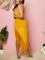 A woman models the back of a yellow fringe mini dress with a halter neckline.