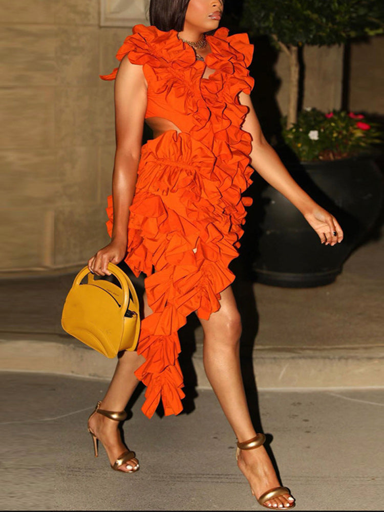 Side view of a woman in an orange ruffled mini dress and yellow handbag