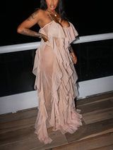 Side view of a woman in a long, layered ruffled dress.