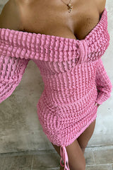 Detailed view of the textured fabric and bow detail on a pink off-the-shoulder mini dress.