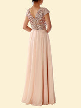 Back view of a woman in a blush pink sequined formal dress