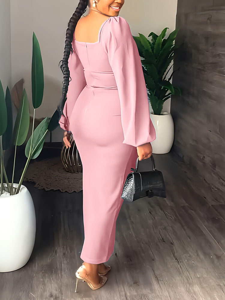 Rear view of a woman in a fitted pink dress with a high slit and long puff sleeves.