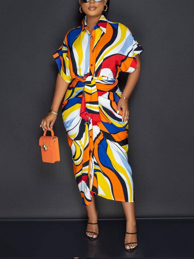 Side view of a woman in a vibrant abstract print shirt dress.