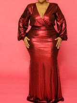 Close-up of a woman in a red metallic dress, showing the V-neckline and fitted silhouette