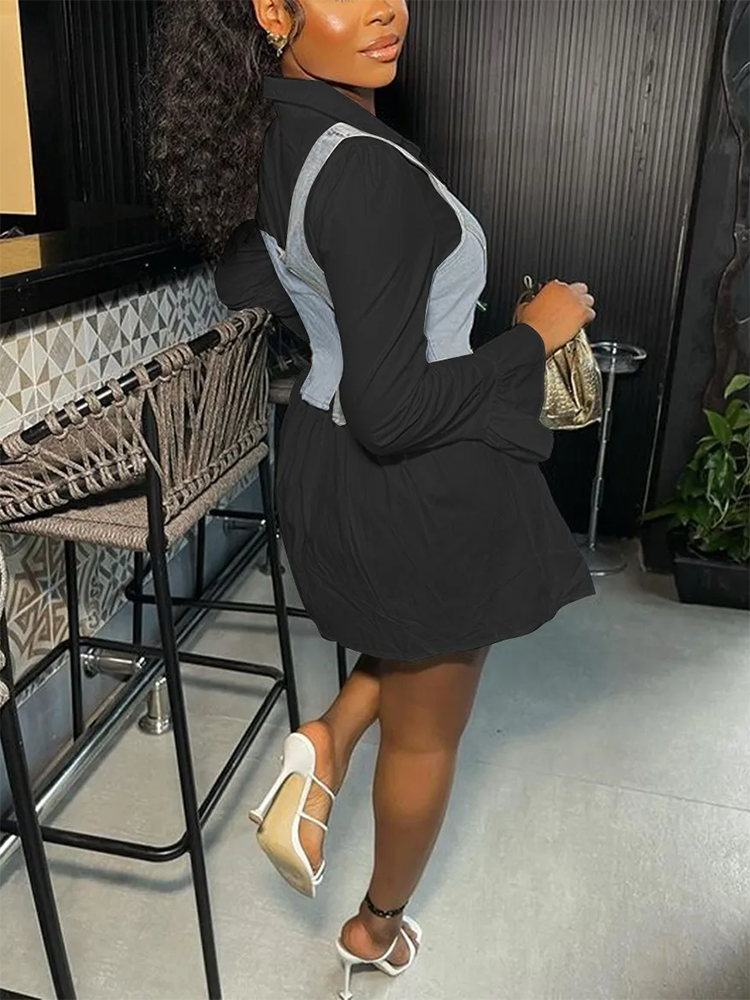 Side view of a woman in a black collared shirt dress with a denim vest overlay and white heels