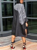 rear view of a woman in a black and brown color block midi shirt dress with white stripes